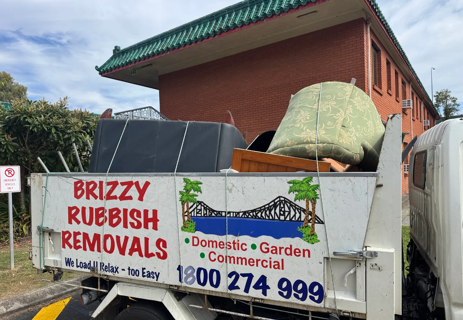 Brizzy Rubbish Removals truck loaded with old couches and an armchair in Brisbane.
