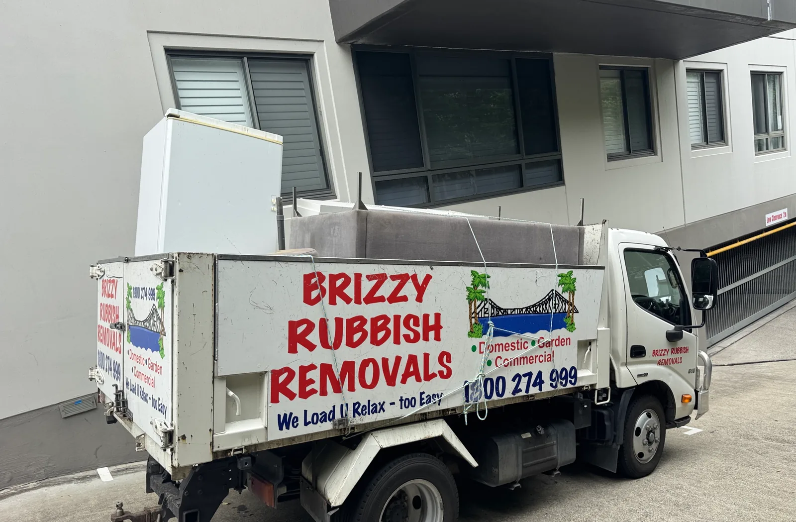 Brizzy Rubbish Removals truck loaded with a fridge at a Brisbane apartment.