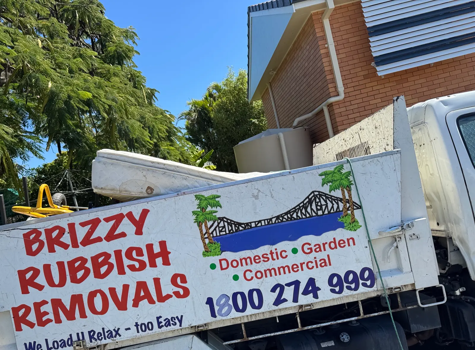 Brizzy Rubbish Removals truck loaded with a mattress at a Brisbane home.