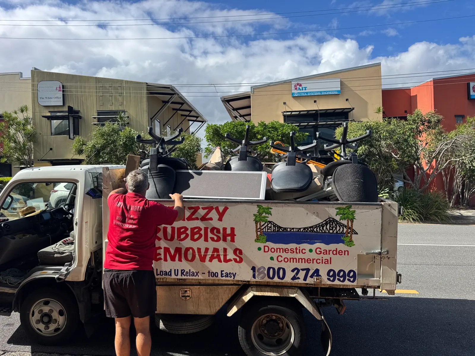Brizzy Rubbish Removals worker loading office chairs during an office clearance in Brisbane