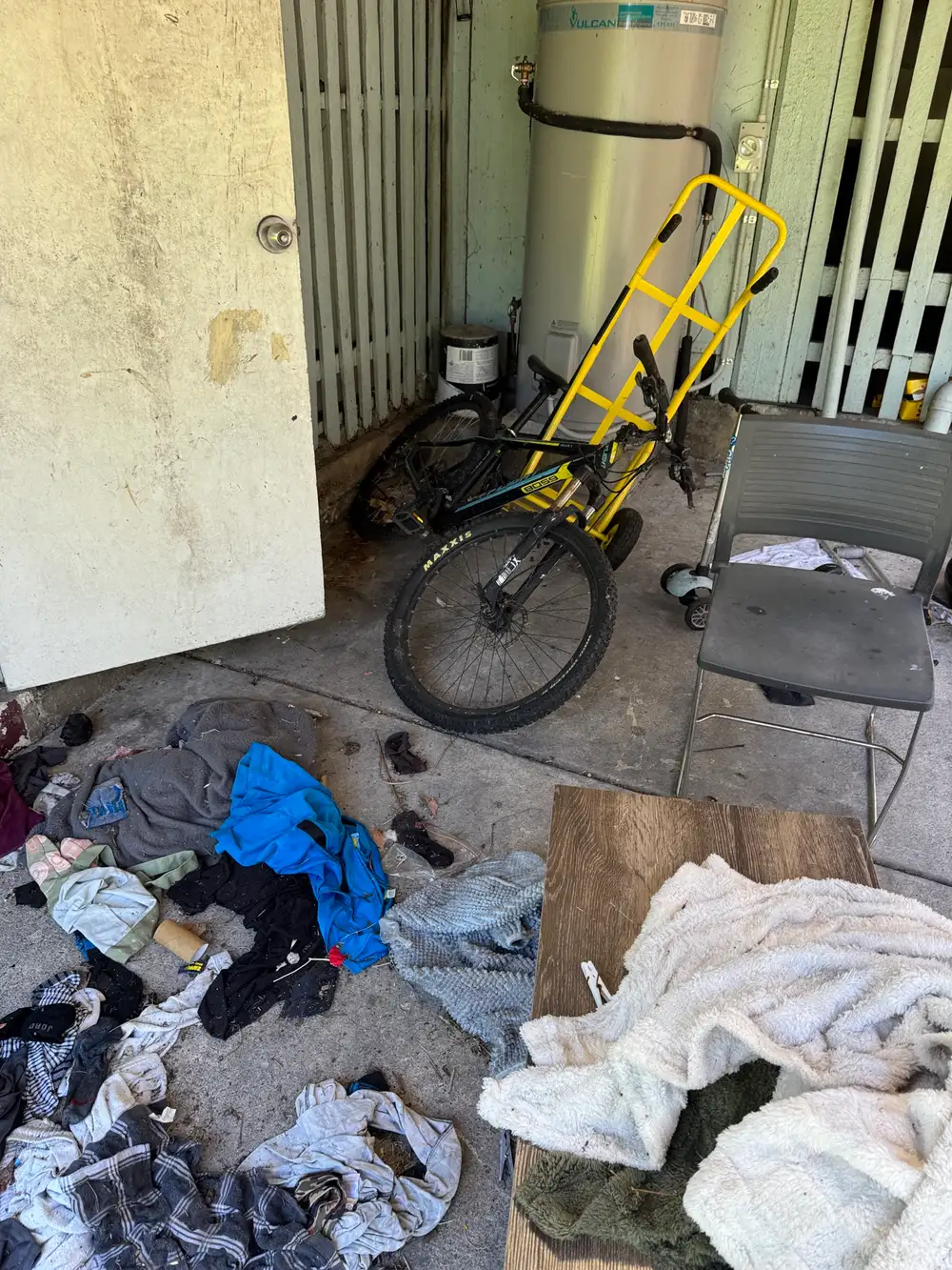 Household clutter and old bicycle under a Queenslander house in Grange, Brisbane