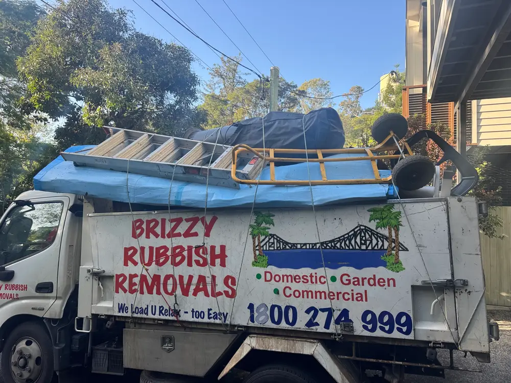 Loaded rubbish removal truck with household furniture and mattress, Paddington