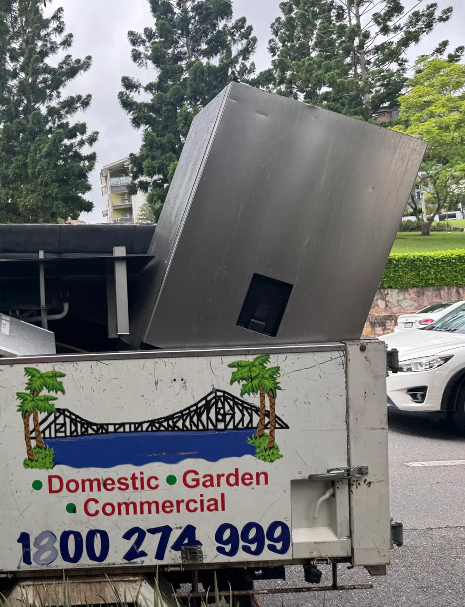 Old fridge and appliance loaded onto Brizzy Rubbish Removals truck for whitegoods removal in Brisbane